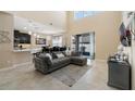 Bright living room features high ceilings, an open layout, tile floors, and a gray sectional couch at 12189 Beach Fern Rd, Orlando, FL 32824