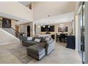 Bright living room features high ceilings, an open layout, tile floors, and a gray sectional couch at 12189 Beach Fern Rd, Orlando, FL 32824