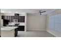 A modern kitchen features stainless steel appliances, dark wood cabinets, and an eat-in area with tile floors at 15471 Honeybell Dr, Winter Garden, FL 34787