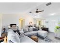 Open living room with vaulted ceiling, ceiling fan, hardwood floors, and natural light at 2101 Lake Francis Dr, Apopka, FL 32712