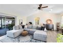 Spacious living room with neutral decor, ceiling fan, and sliding glass doors to the patio at 2101 Lake Francis Dr, Apopka, FL 32712