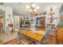Cozy dining room featuring a chandelier, wainscoting, and wood-look floors at 2326 Wintermere Pointe Dr, Winter Garden, FL 34787