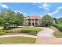 Expansive front lawn and curved driveway leading up to the house at 3414 Cocard Ct, Windermere, FL 34786