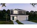 Charming two-story home with gray accents, a two-car garage, and a well-manicured lawn at 3860 Bluethread Way, Poinciana, FL 34759