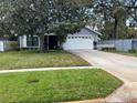 Charming single-story home with a well-maintained lawn and a two-car garage at 418 S Summerlin Ave, Sanford, FL 32771