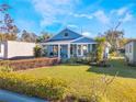 Charming blue home with a well-manicured lawn and lush landscaping at 434 E Harding St, Orlando, FL 32806