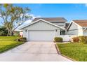 Charming home with a two-car garage, well-maintained driveway and beautifully landscaped yard at 53 Fore Dr, New Smyrna Beach, FL 32168