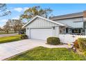 Two-car garage of charming home featuring landscaped yard and well-maintained exterior in a vibrant neighborhood at 53 Fore Dr, New Smyrna Beach, FL 32168