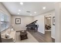 Cozy living room featuring a grand piano, neutral tones, and an inviting atmosphere with an open doorway at 655 E Lake View Rd, Lake Alfred, FL 33850