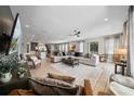Bright living room boasts an open floor plan, tile floors, and a cozy seating area with a large sectional sofa at 7702 Fairfax Dr, Kissimmee, FL 34747