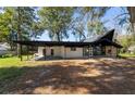 Contemporary home featuring a covered carport, stone fireplace, and expansive windows offering ample natural light at 812 2Nd St, Altamonte Springs, FL 32701