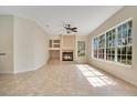 Bright living room with a fireplace and an abundance of natural light from the many windows at 827 Royalwood Ln, Oviedo, FL 32765