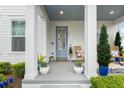 Cozy front porch with rocking chairs, potted plants, a welcome mat, and a painted ceiling at 932 Kylee Aly, Winter Garden, FL 34787