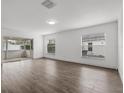 Sun-filled living room boasts wood-look floors, sliding door access to lanai and bright ambiance at 1063 Eagles Forrest, Apopka, FL 32712