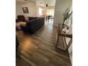 Living room featuring wood-look floors, dark furniture, and an open floor plan at 12538 Indiana Woods Ln, Orlando, FL 32824