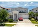 The exterior view shows a two-story home with a two-car garage and manicured landscaping at 15724 Cutter Sail Pl, Winter Garden, FL 34787