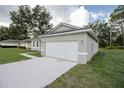 Attached two-car garage with a concrete driveway, providing ample parking space at 16819 Sw 41St Avenue Rd, Ocala, FL 34473