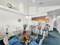 Dining room featuring a glass-top table with seating for six next to the kitchen bar at 2040 Royal Bay Blvd # 30, Kissimmee, FL 34746
