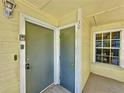 Exterior view of the condo entrance with a key box, two doors and a small window at 2040 Royal Bay Blvd # 30, Kissimmee, FL 34746