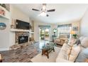 Cozy living room with stone fireplace, comfortable seating, and views of the outdoor patio at 2621 Talon Ct, Orlando, FL 32837