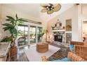 Living room with stone fireplace, vaulted ceilings, nautical decor and sliding doors to outdoor patio at 2621 Talon Ct, Orlando, FL 32837
