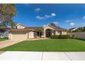 Beautiful one-story home with well-kept lawn, two car garage and mature landscaping at 2901 Eagle Lake Dr, Orlando, FL 32837