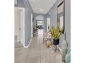 Inviting home entryway featuring tile flooring, a high ceiling, neutral paint, and decorative accents at 3308 Country Walk Club Cir, Winter Haven, FL 33881
