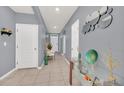 Bright and airy entryway featuring gray walls, tiled floors, arched doorways and decorative accents at 3308 Country Walk Club Cir, Winter Haven, FL 33881