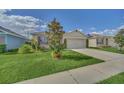 A well-maintained single-Gathering home in a residential neighborhood featuring lush grass and mature landscaping at 3308 Country Walk Club Cir, Winter Haven, FL 33881