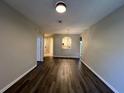 The living room showcases wood floors, neutral walls, and an arched opening to the kitchen area at 3332 Robert Trent Jones Dr # 10703, Orlando, FL 32835