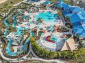 Aerial view of community amenities showcasing an expansive pool, lazy river, and lounge areas at 3356 Lilac Way, Davenport, FL 33897