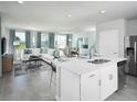 Open floor plan with ample natural light featuring stainless appliances and modern finishes at 4353 Switchgrass Ln, St Cloud, FL 34772