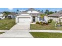 Charming single-Gathering home with a two-car garage, concrete driveway and meticulously maintained lawn at 512 Stowers Dr, New Smyrna Beach, FL 32168