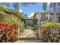 View of front entrance featuring a brick walkway, manicured foliage, and updated outdoor lighting at 605 Sweetbriar Rd, Orlando, FL 32806