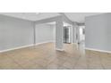 Open living room with light walls, tile floors, and natural lighting at 626 Golden Sunshine Cir, Orlando, FL 32807