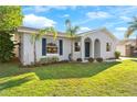Charming single-story home with palm trees and a well-manicured front lawn at 649 Caribou Ct, Poinciana, FL 34759