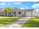 A single-story home is showcased, complete with a concrete driveway and lush green lawn at 649 Caribou Ct, Poinciana, FL 34759