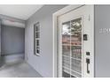Hallway with a light gray wall and white door with glass panels and silver door number at 660 Celebration Ave # 220, Celebration, FL 34747