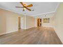 Open-concept living room with fan and view of the kitchen pass-through at 7508 Toscana Blvd # 123, Orlando, FL 32819