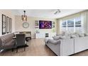 Spacious living room featuring a large sectional sofa and a modern entertainment center at 8743 Sidley Ln, Orlando, FL 32832