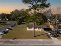 An elevated perspective of a cozy single-story home with a spacious lot, street view, and mature trees at 925 Valleydale Ave, Deland, FL 32720