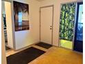 View of the home's foyer with tile flooring, neutral paint, and two rugs at 10223 Marco Polo Dr, Orlando, FL 32821