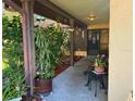 Inviting covered front porch featuring lush greenery and charming decorative accents at 10223 Marco Polo Dr, Orlando, FL 32821