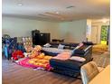 Spacious living room with laminate flooring and a large sofa for relaxing and entertaining at 10223 Marco Polo Dr, Orlando, FL 32821