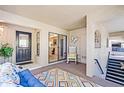 Screened outdoor living space with tile floors, white rocking chair, and sliding doors to the kitchen at 1055 Kensington Park Dr # 609, Altamonte Springs, FL 32714