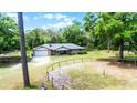 Aerial view of home with an attached garage and fenced yard under a sunny, blue sky at 1095 Grand Ave, Orange City, FL 32763