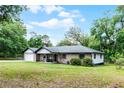 Well-maintained single-story brick home with a lush lawn and mature trees offers a peaceful setting at 1095 Grand Ave, Orange City, FL 32763