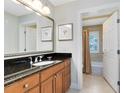 Bathroom with vanity and a shower/tub combo, featuring a large framed mirror and tile floors at 1360 Centre Court Ridge Dr # 201, Reunion, FL 34747