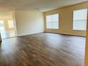 Spacious living room showcases laminate flooring and ample natural light at 15090 Waterford Chase Pkwy, Orlando, FL 32828