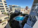 Community Pool with clear blue water, surrounded by mature landscaping and city views at 155 S Court Ave # 1506, Orlando, FL 32801